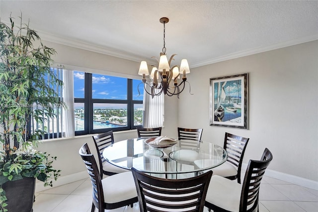 tiled dining space featuring crown molding, a textured ceiling, and a notable chandelier