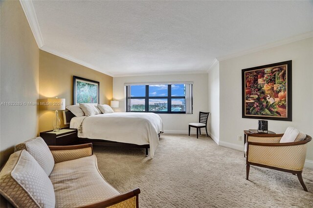 bedroom featuring carpet floors, a textured ceiling, and crown molding