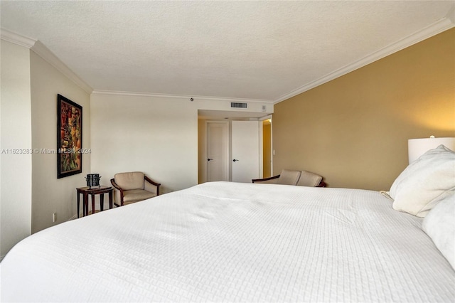 bedroom with crown molding and a textured ceiling