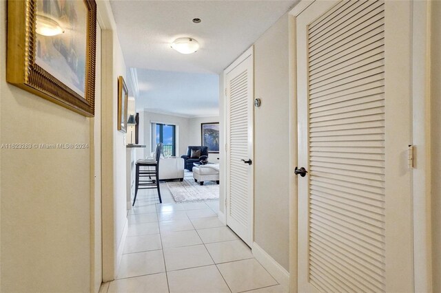 hallway featuring light tile patterned floors