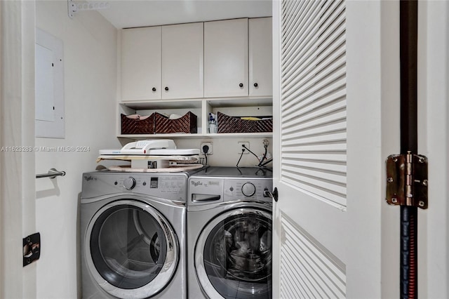 clothes washing area featuring cabinets, electric panel, and washing machine and clothes dryer