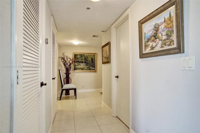 corridor with light tile patterned flooring