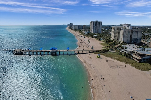 birds eye view of property with a water view and a view of the beach