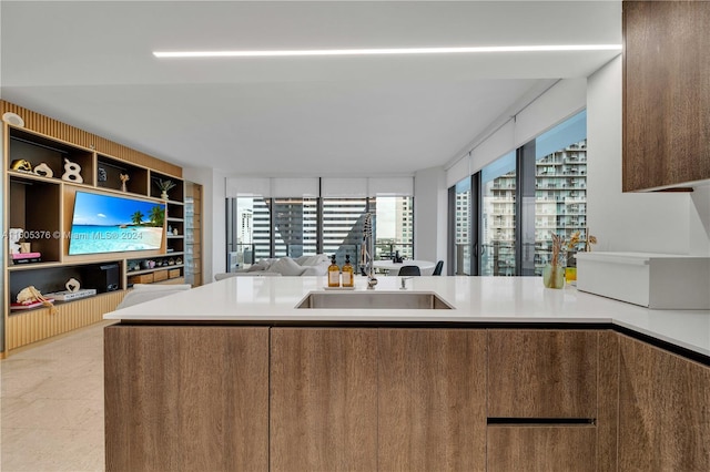 kitchen featuring sink, light tile patterned floors, and kitchen peninsula