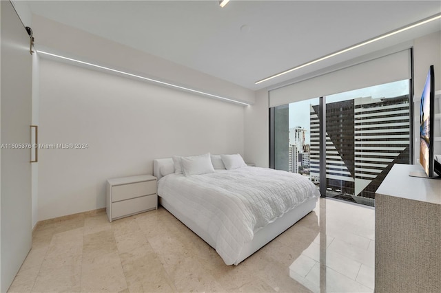 bedroom with light tile patterned flooring and access to exterior