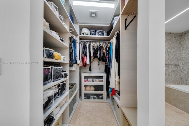 spacious closet featuring light tile patterned floors