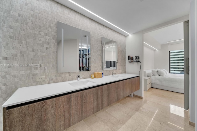 bathroom featuring double vanity, tile walls, and tile patterned floors