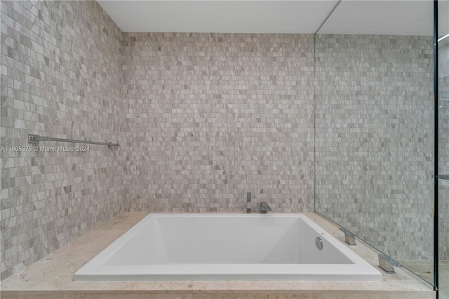 bathroom with tiled tub