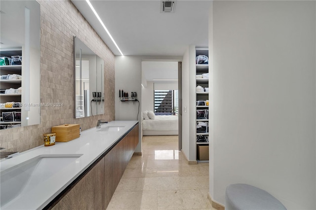 bathroom featuring tile patterned floors and dual bowl vanity