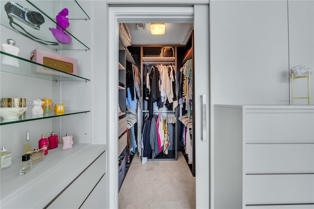 spacious closet with light tile patterned floors