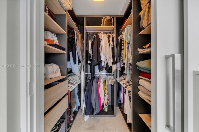 spacious closet featuring light tile patterned floors