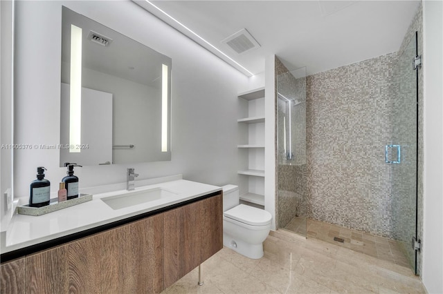 bathroom with vanity, a shower with door, tile patterned flooring, and toilet