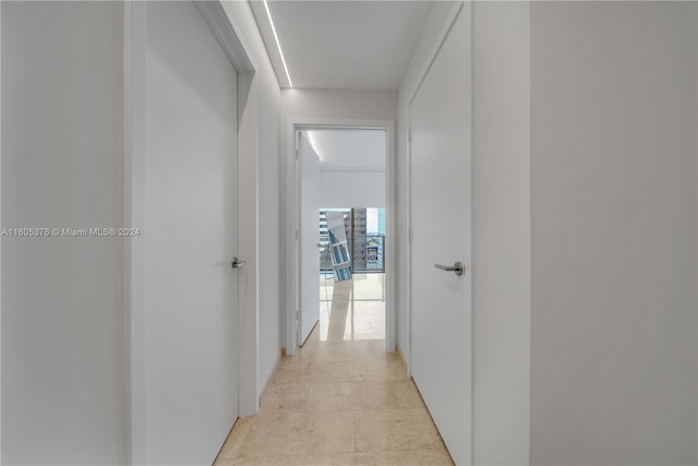 hall with light tile patterned floors