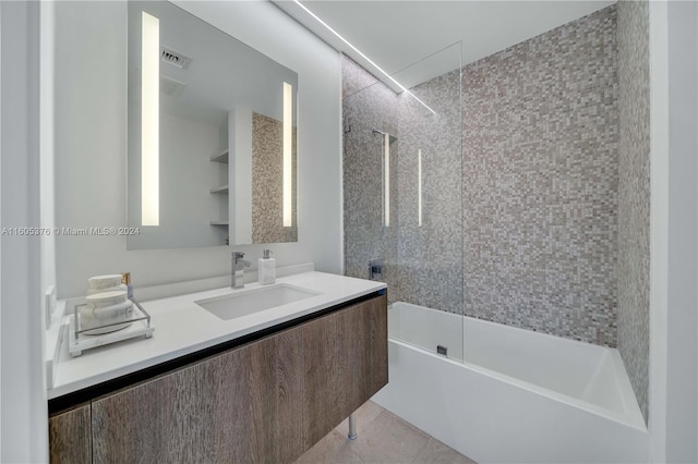 bathroom featuring tiled shower / bath combo, vanity, and tile patterned floors