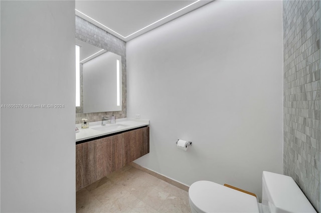 bathroom featuring tile patterned floors, vanity, backsplash, and toilet