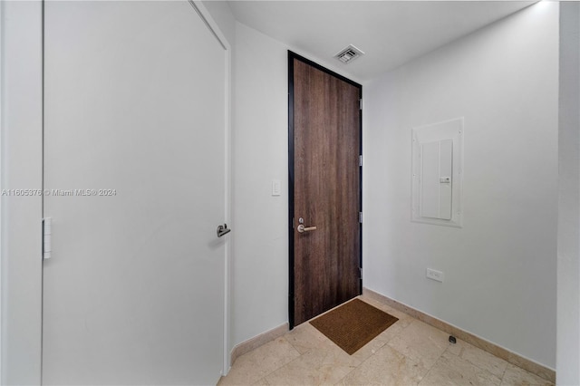 interior space featuring light tile patterned flooring and electric panel