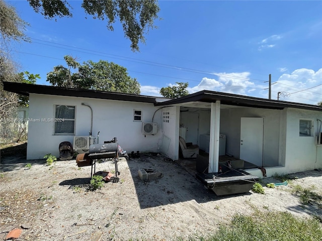 rear view of house featuring ac unit