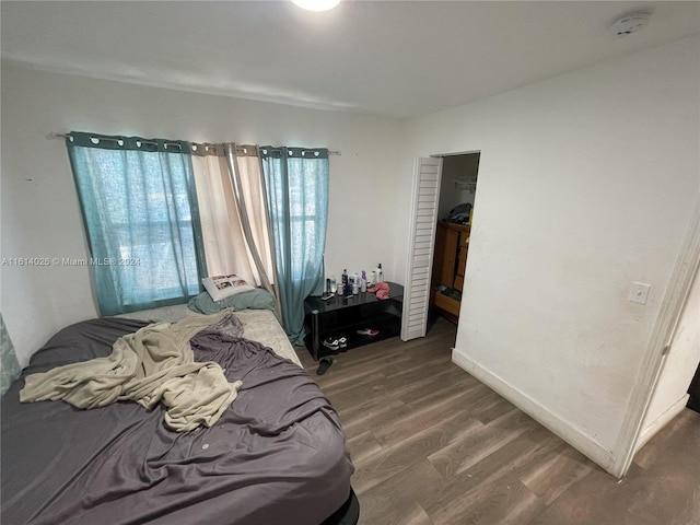 bedroom featuring dark hardwood / wood-style flooring and a closet