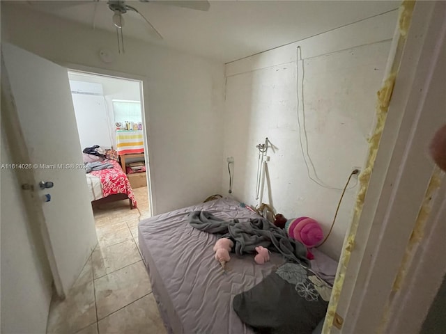 bedroom featuring light tile patterned floors and ceiling fan