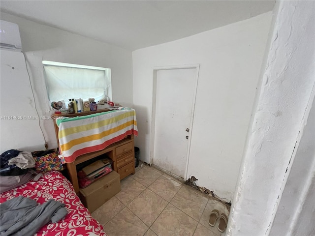 bedroom with an AC wall unit