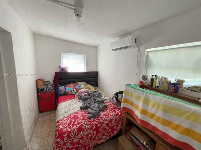 bedroom with light tile patterned floors, vaulted ceiling, and an AC wall unit