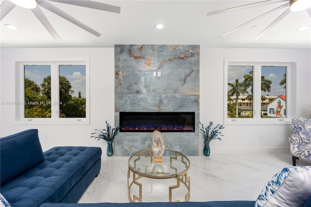 living room featuring a fireplace and ceiling fan