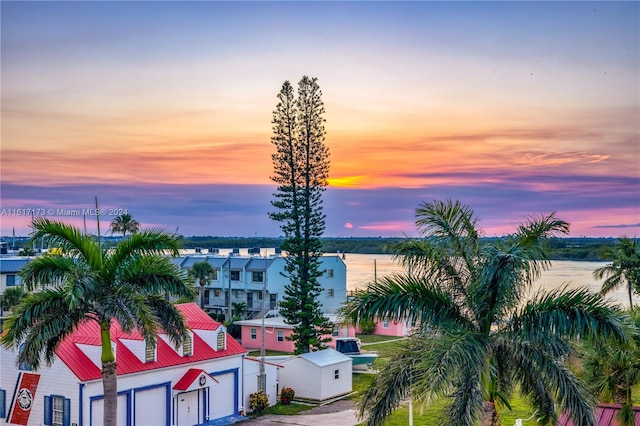 aerial view at dusk with a water view