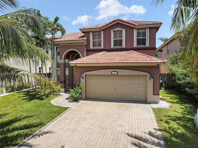 mediterranean / spanish-style house featuring a front yard and a garage