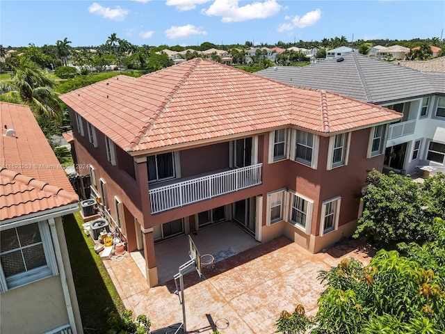 back of property featuring a balcony, cooling unit, and a patio area