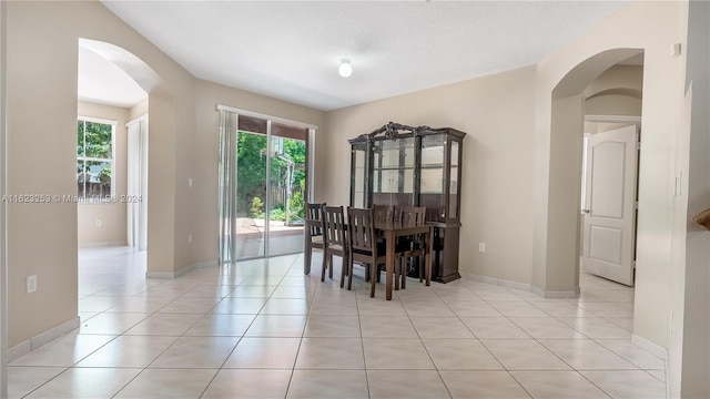 dining area with light tile patterned floors