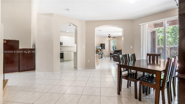 dining space with ceiling fan and light tile patterned floors