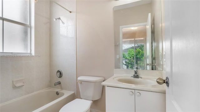 full bathroom with plenty of natural light, vanity, tiled shower / bath, and toilet