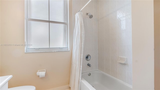 full bathroom featuring shower / tub combo with curtain, toilet, and vanity