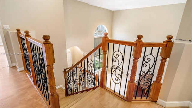 stairs featuring hardwood / wood-style flooring