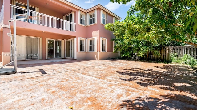 back of house featuring a patio area and a balcony