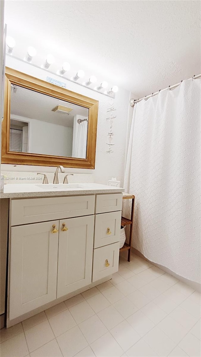 bathroom featuring tile patterned floors and vanity