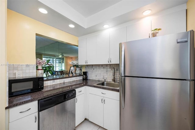 kitchen featuring decorative backsplash, stainless steel appliances, sink, and white cabinets