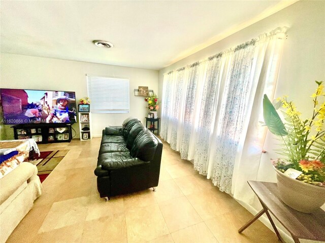 tiled dining space with ceiling fan