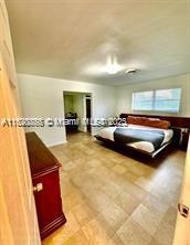 bathroom with tile patterned floors, walk in shower, and toilet