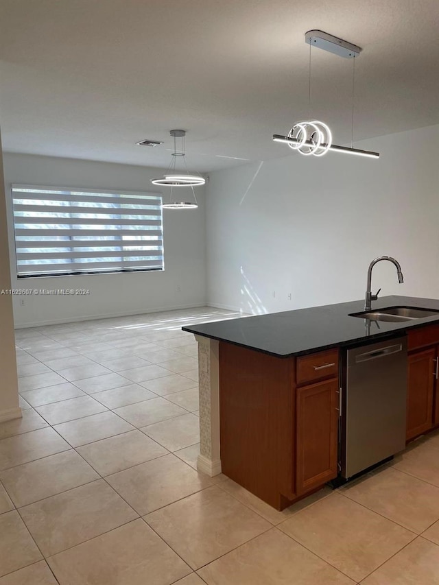 kitchen with dishwasher, sink, light tile patterned floors, and pendant lighting