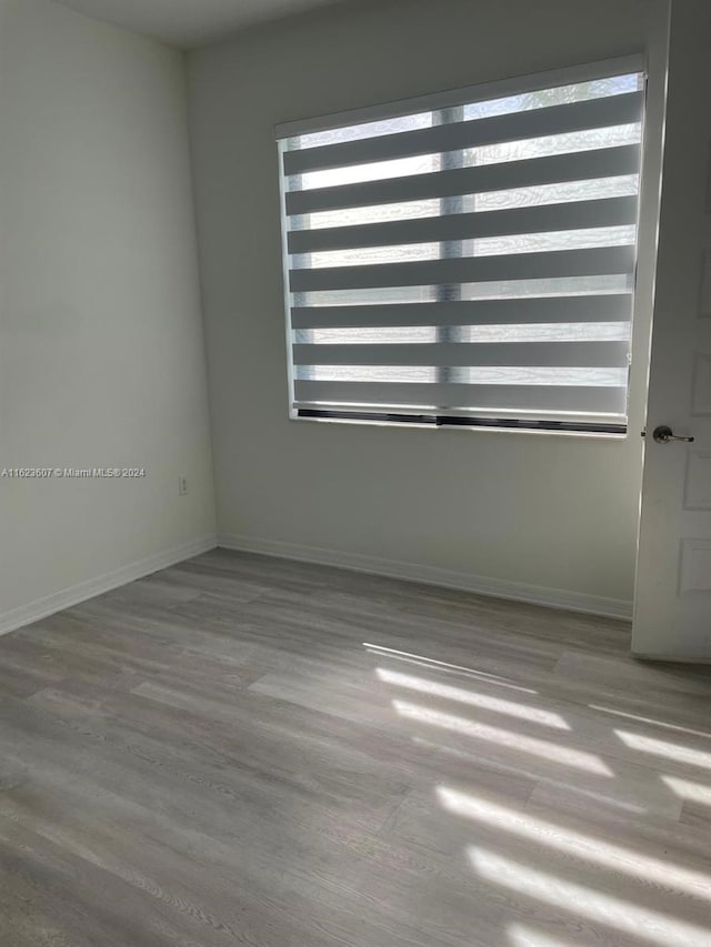 spare room with hardwood / wood-style floors