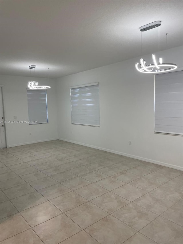 spare room featuring a notable chandelier