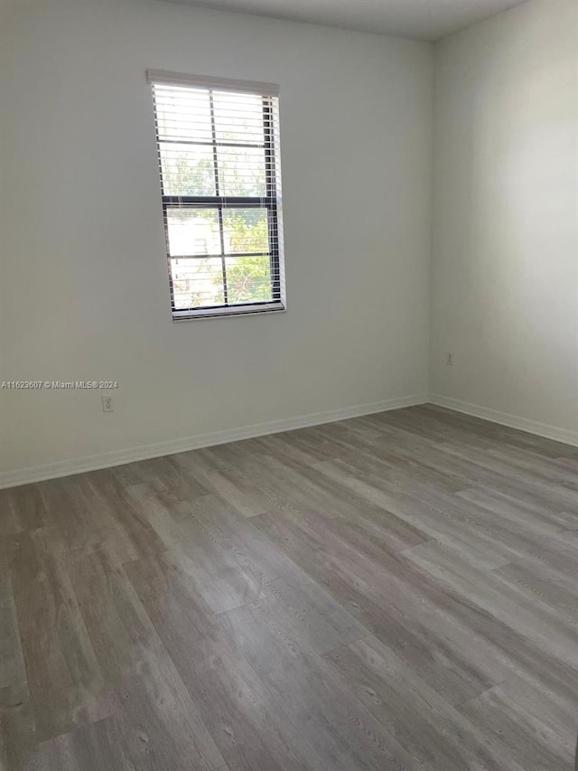 unfurnished room with wood-type flooring