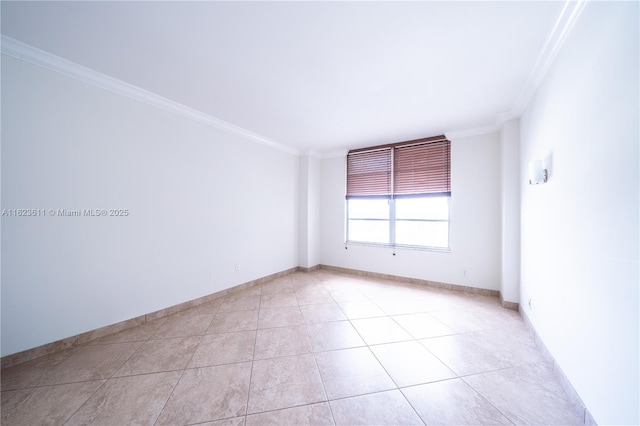 spare room with light tile patterned floors, baseboards, and ornamental molding