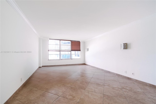 empty room with ornamental molding and light tile patterned floors