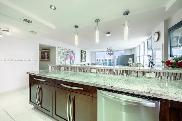 3800 S Ocean Dr Unit 1512A, Hollywood, FL 33019 - kitchen featuring stainless steel dishwasher, light stone counters, hanging light fixtures, and light tile patterned floors