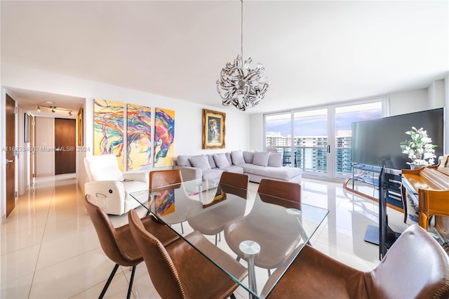 dining room with light tile patterned flooring, expansive windows, and an inviting chandelier