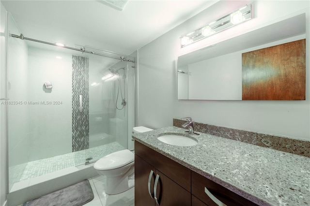 bathroom with tile patterned flooring, an enclosed shower, vanity, and toilet