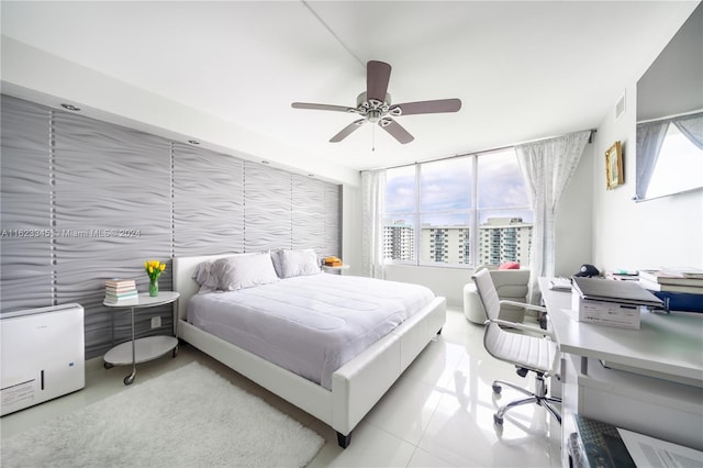 tiled bedroom with ceiling fan and multiple windows