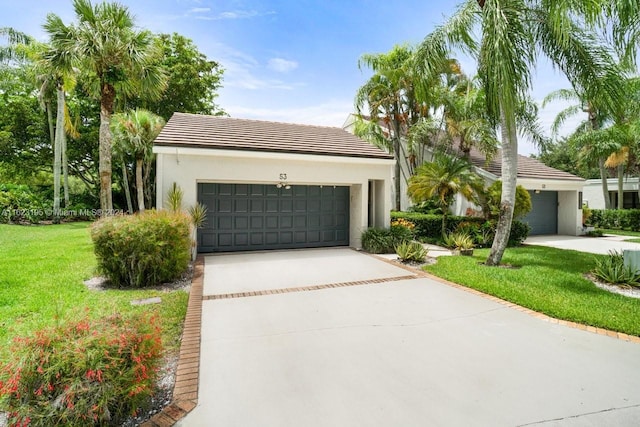 view of front facade with a garage and a front yard